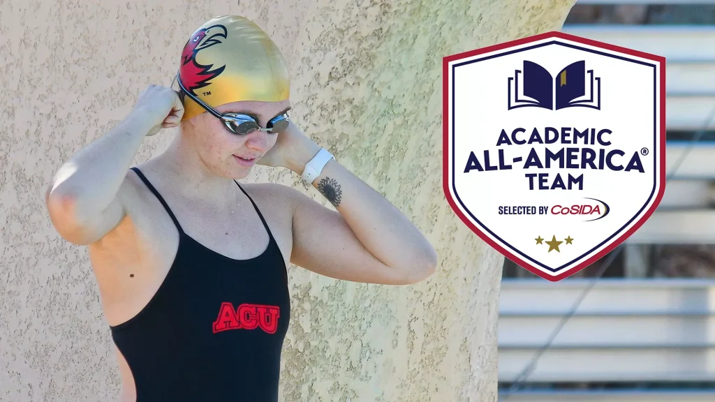 Swimmer in a black swimsuit adjusts goggles beside a textured wall, with an Academic All-America Team badge on the right.